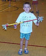 A young lad tries the flower stick in Penarth