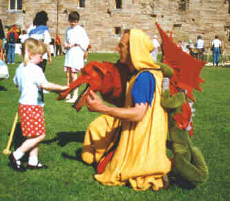 A little girl says "Hello" to Dimart the dragon