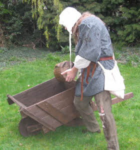 Gongfarmer empties bucket into barrow