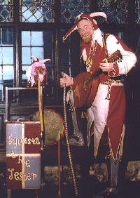 Sylvesta the Jester with his mandorra and box of props.