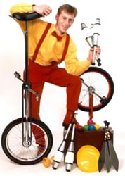 Brett with a range of juggling equipment and unicycle.