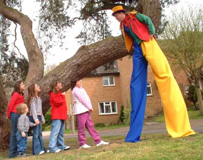 Jonathan chats to kids whilst on his stilts.