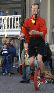 Harry Kingham fire juggling on a unicycle in Chester.